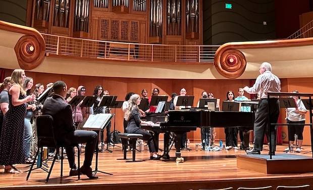 Students on stage practicing choral