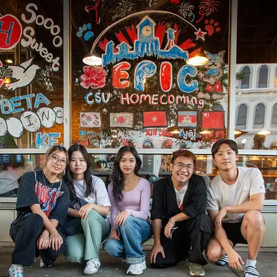 Students painting downtown businesses windows for homecoming