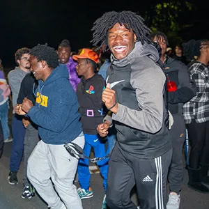 several students smiling and dancing