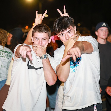 Students pointing at camera