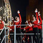 several girls wearing red outfits dancing