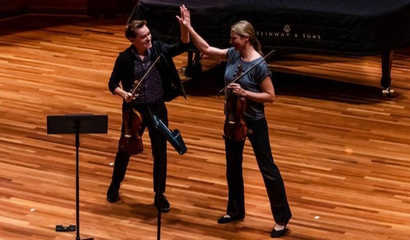 Dr Meidell and Matthew Lipman high five on stage